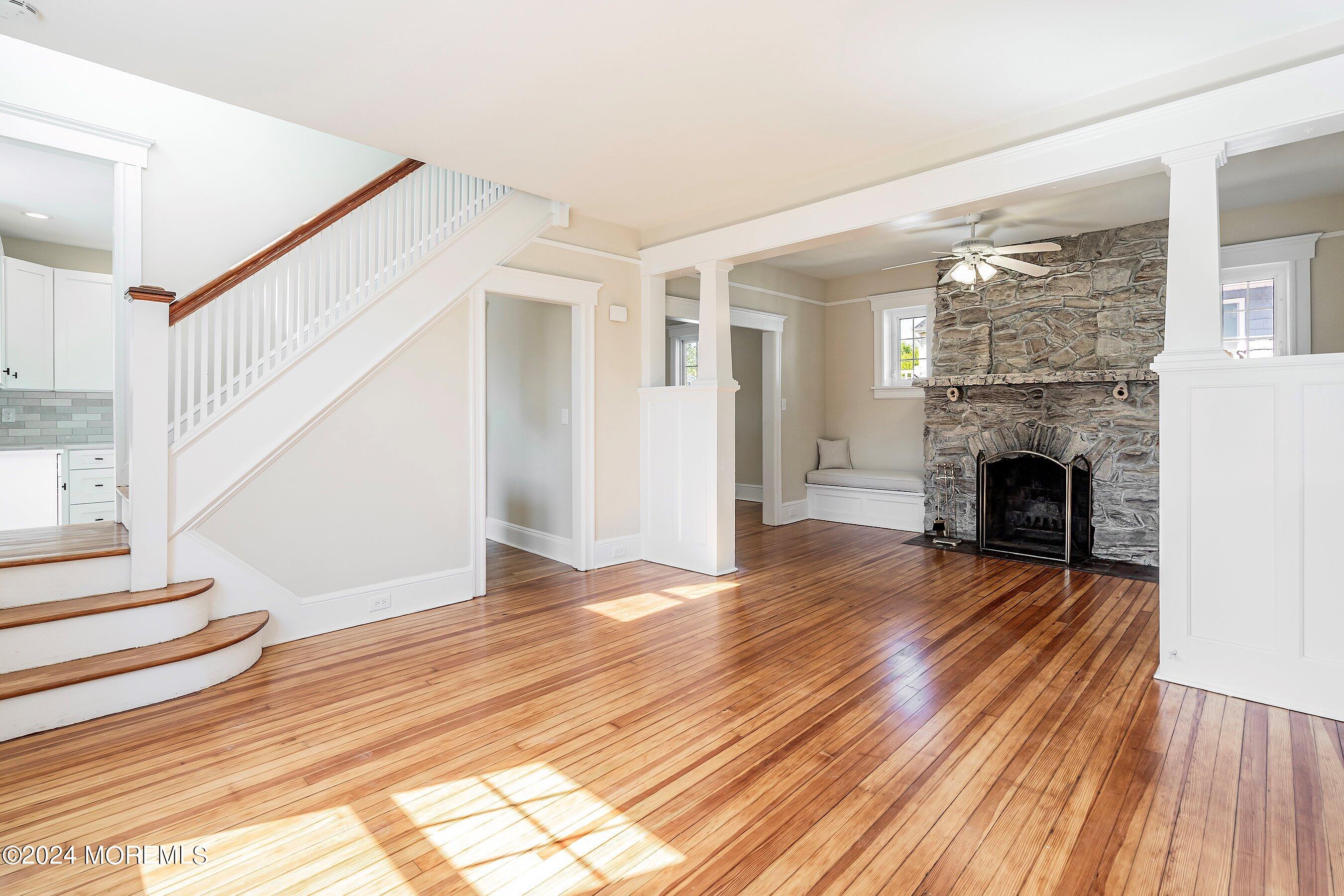 1202 River Road Belmar, NJ 07719 - Photo 11 of 32 a view of a livingroom with wooden floor and a fireplace