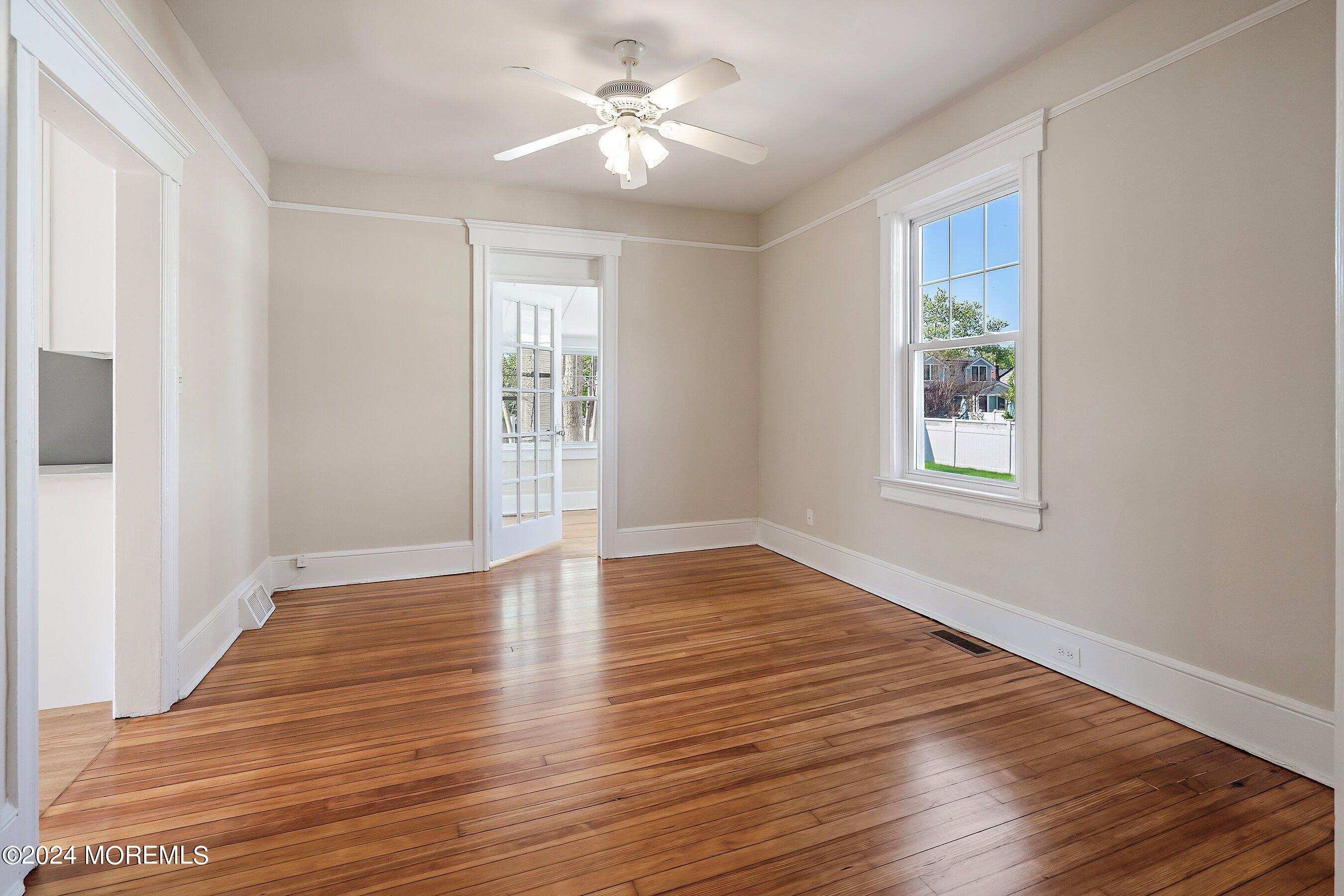 1202 River Road Belmar, NJ 07719 - Photo 17 of 32 a view of empty room with wooden floor and fan