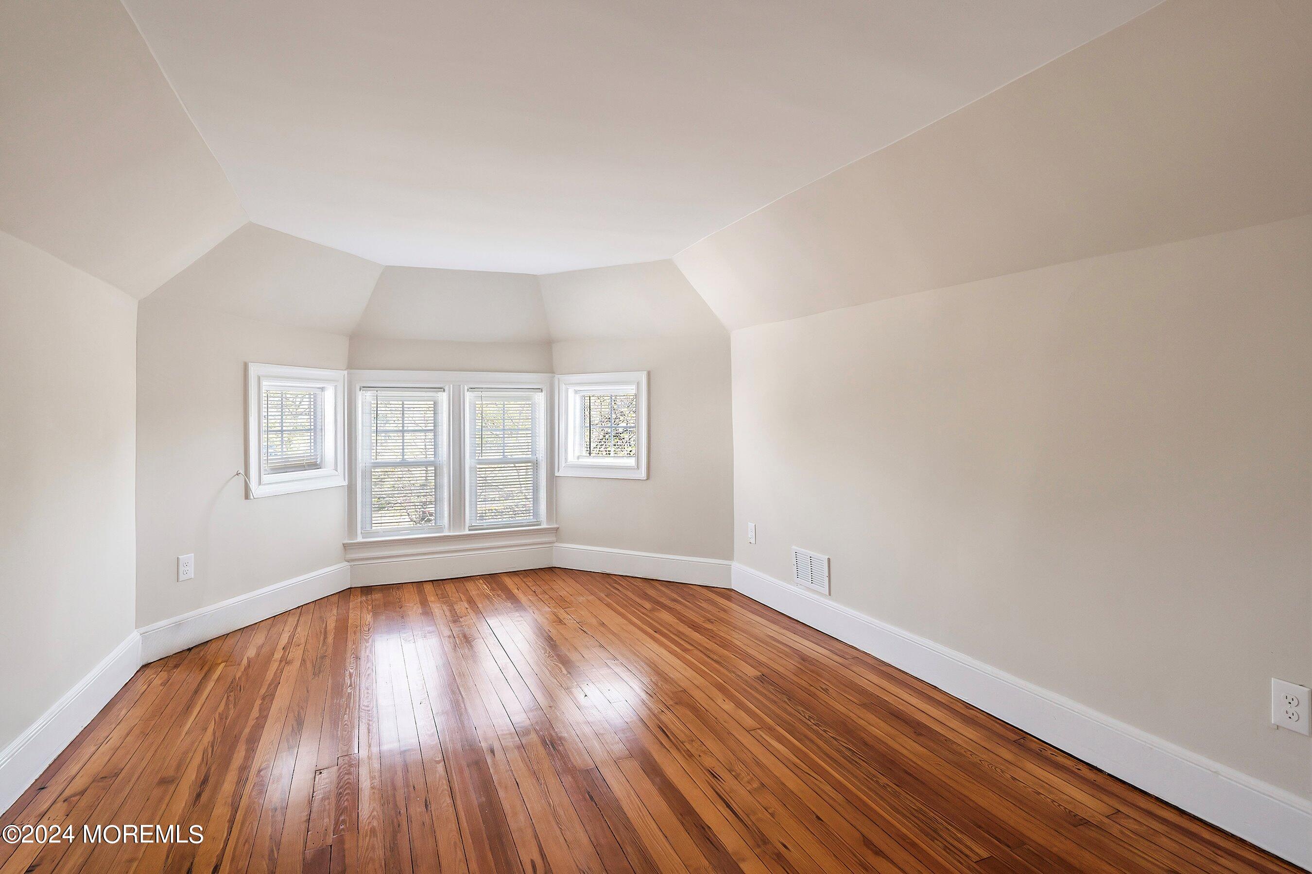 1202 River Road Belmar, NJ 07719 - Photo 21 of 32 wooden floor in an empty room with a window