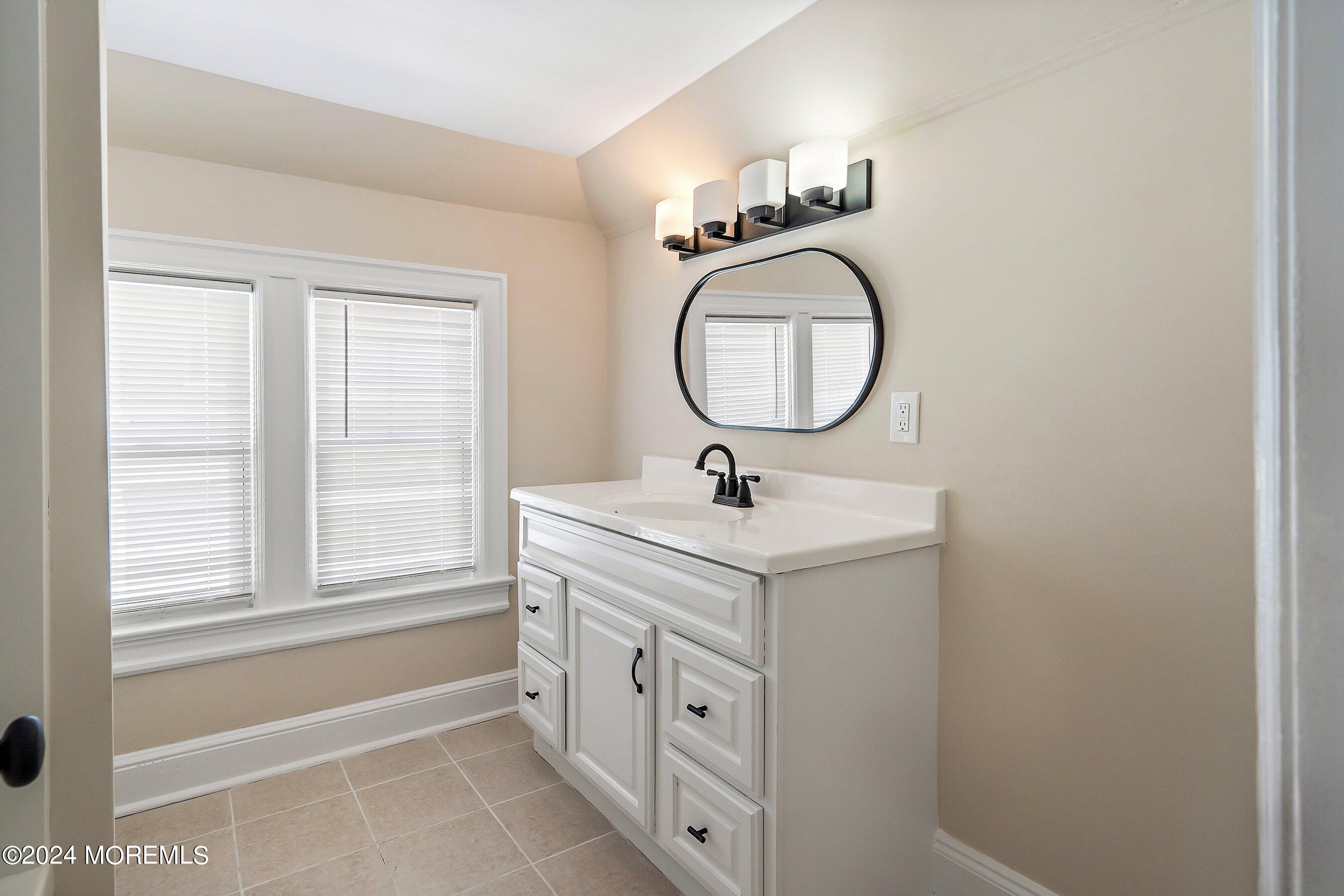 1202 River Road Belmar, NJ 07719 - Photo 22 of 32 a bathroom with a sink and a mirror