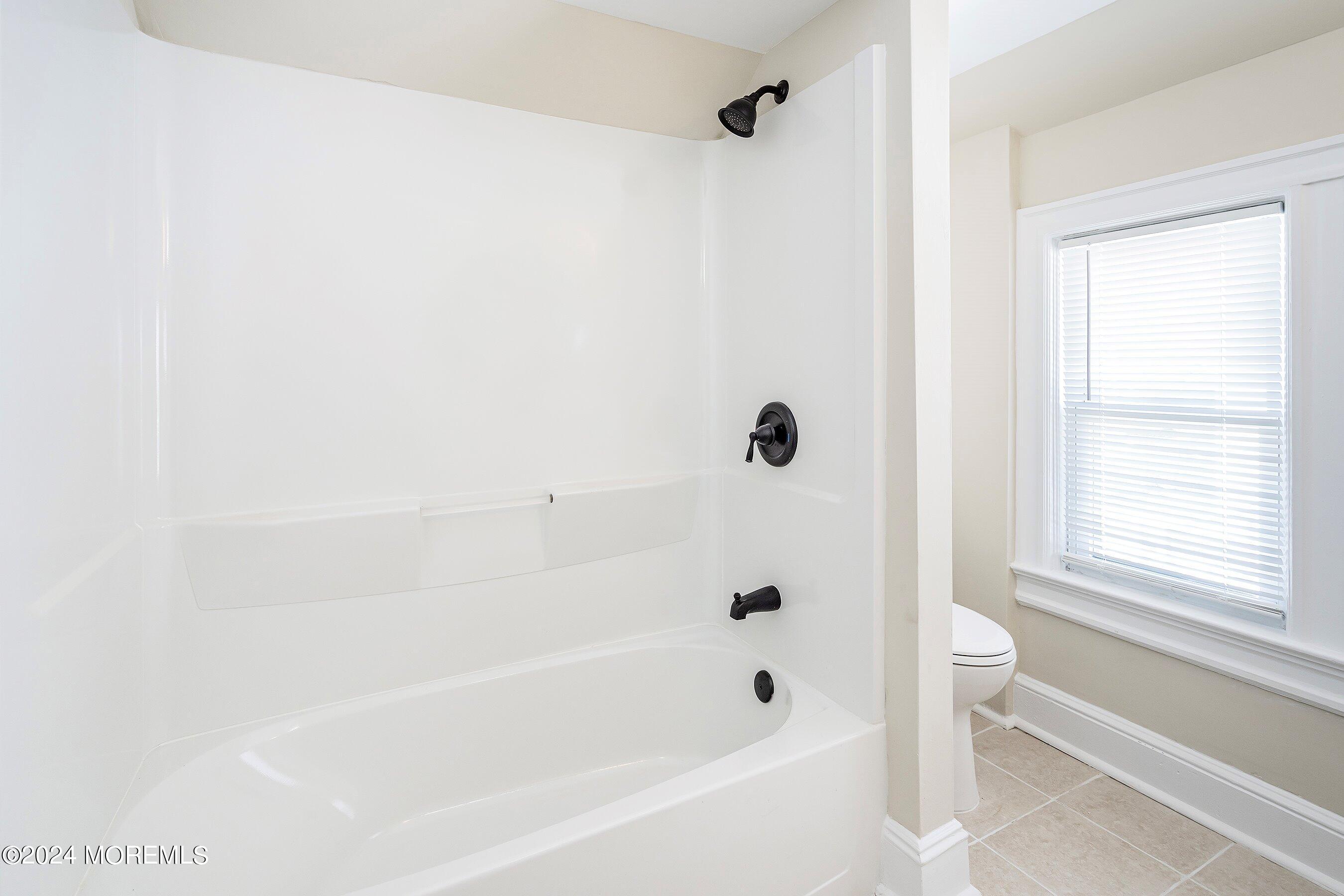 1202 River Road Belmar, NJ 07719 - Photo 23 of 32 a bathroom with a bathtub