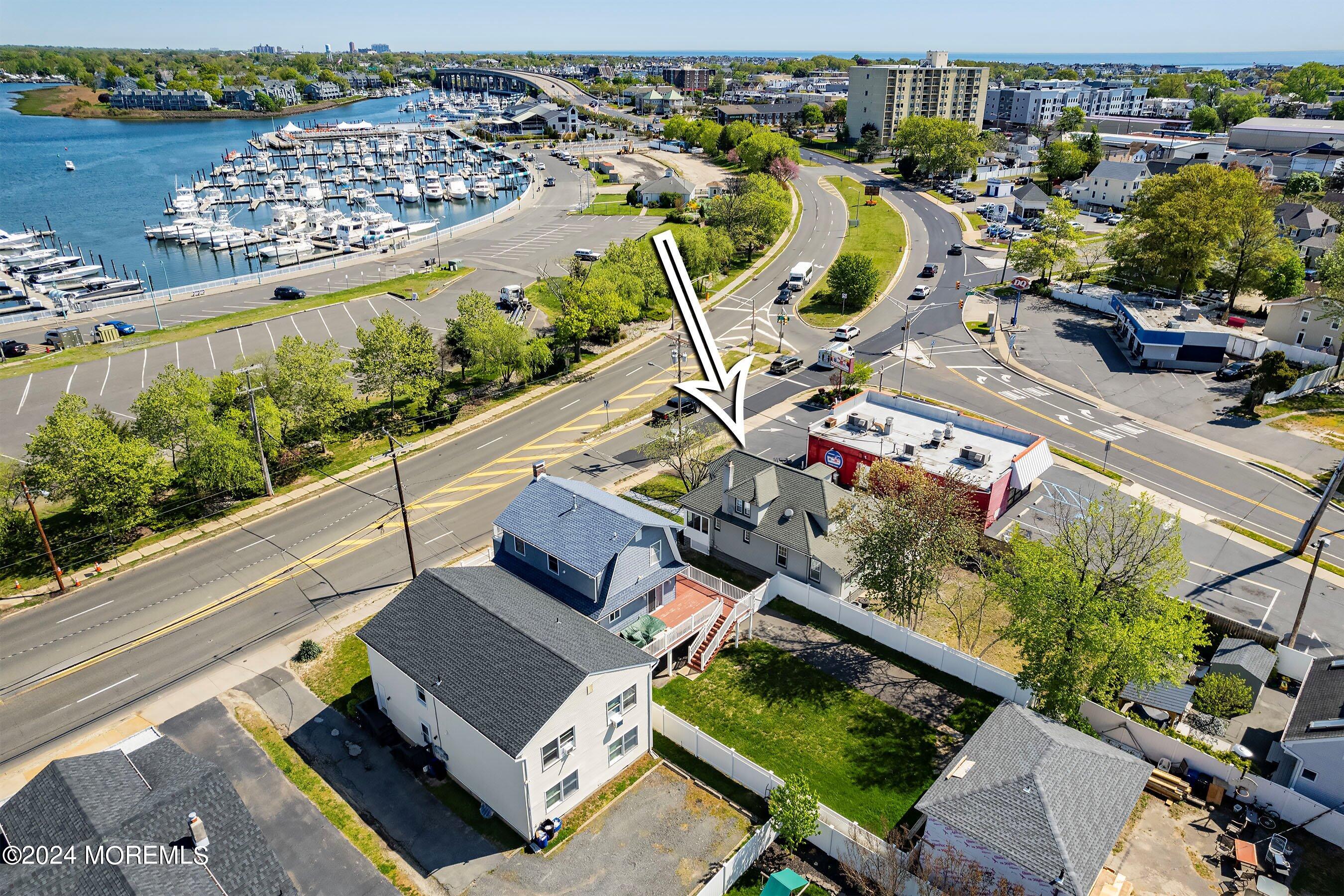 1202 River Road Belmar, NJ 07719 - Photo 3 of 32 an aerial view of a house with a swimming pool patio and lake view