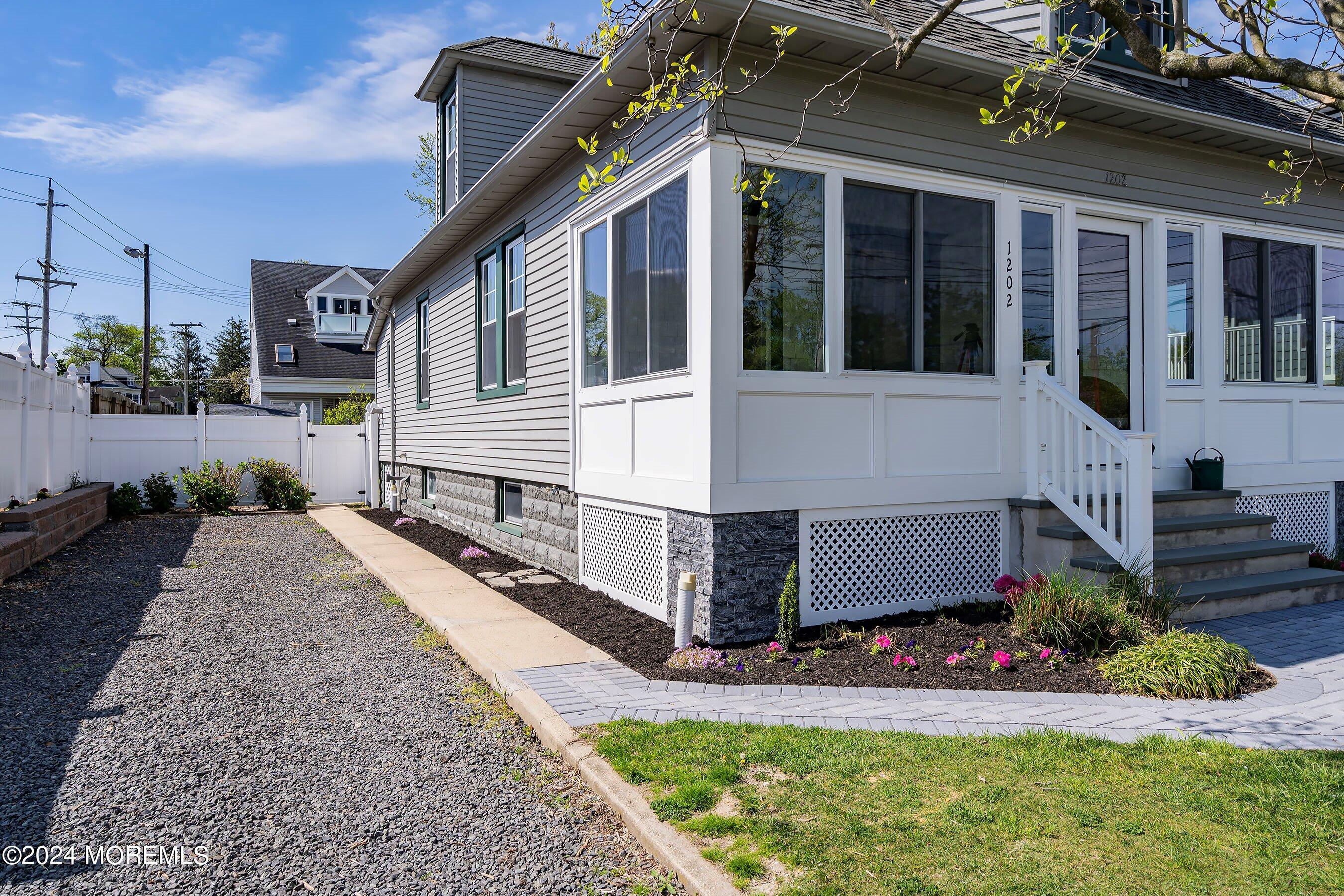 1202 River Road Belmar, NJ 07719 - Photo 4 of 32 a front view of a house with garden
