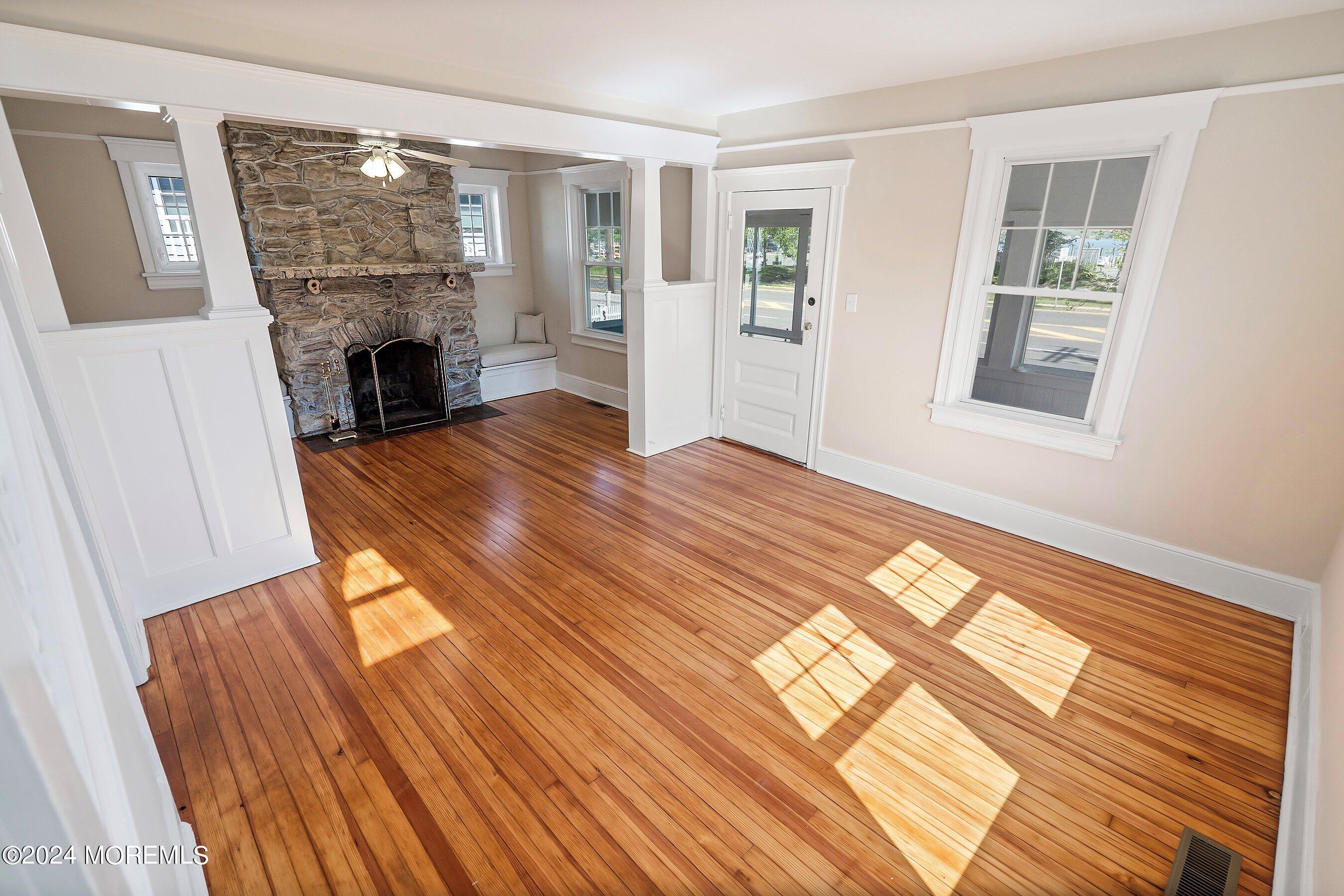 1202 River Road Belmar, NJ 07719 - Photo 10 of 32 a view of empty room with wooden floor and fireplace