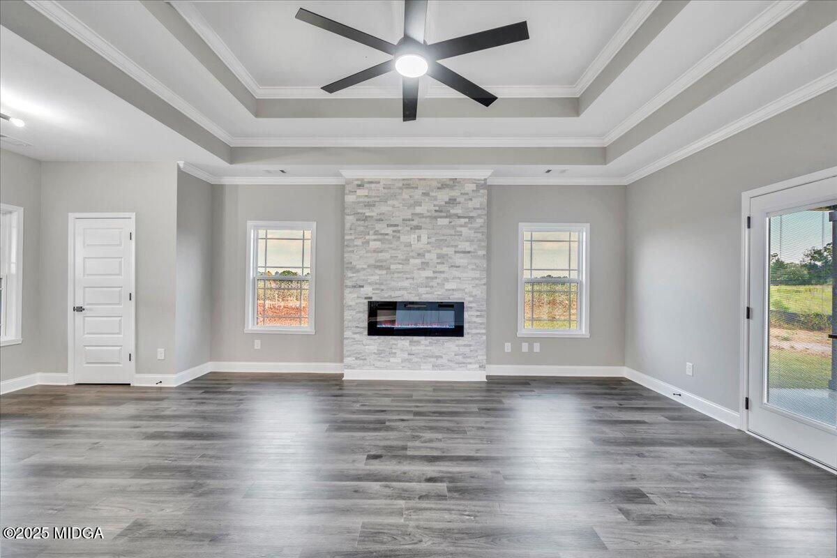 200 Eric Court Byron, GA 31008 - Photo 16 of 58 an empty room with wooden floor fireplace and windows