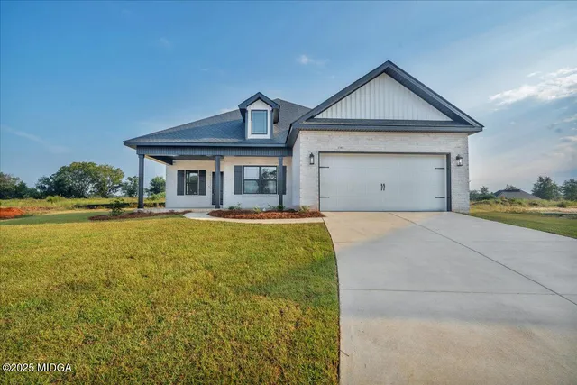 a view of a house with a small yard and wooden fence