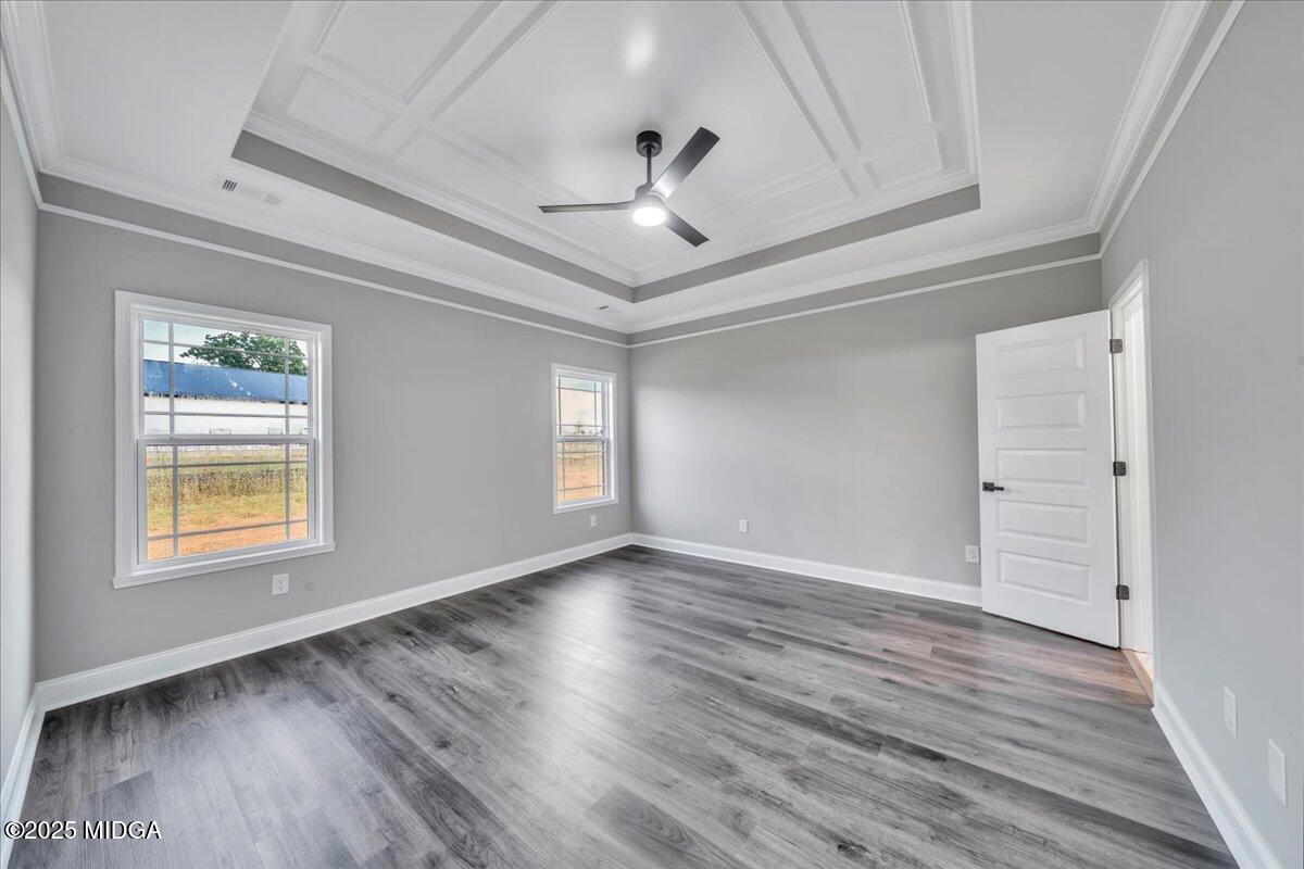 200 Eric Court Byron, GA 31008 - Photo 31 of 58 an empty room with wooden floor chandelier fan and windows