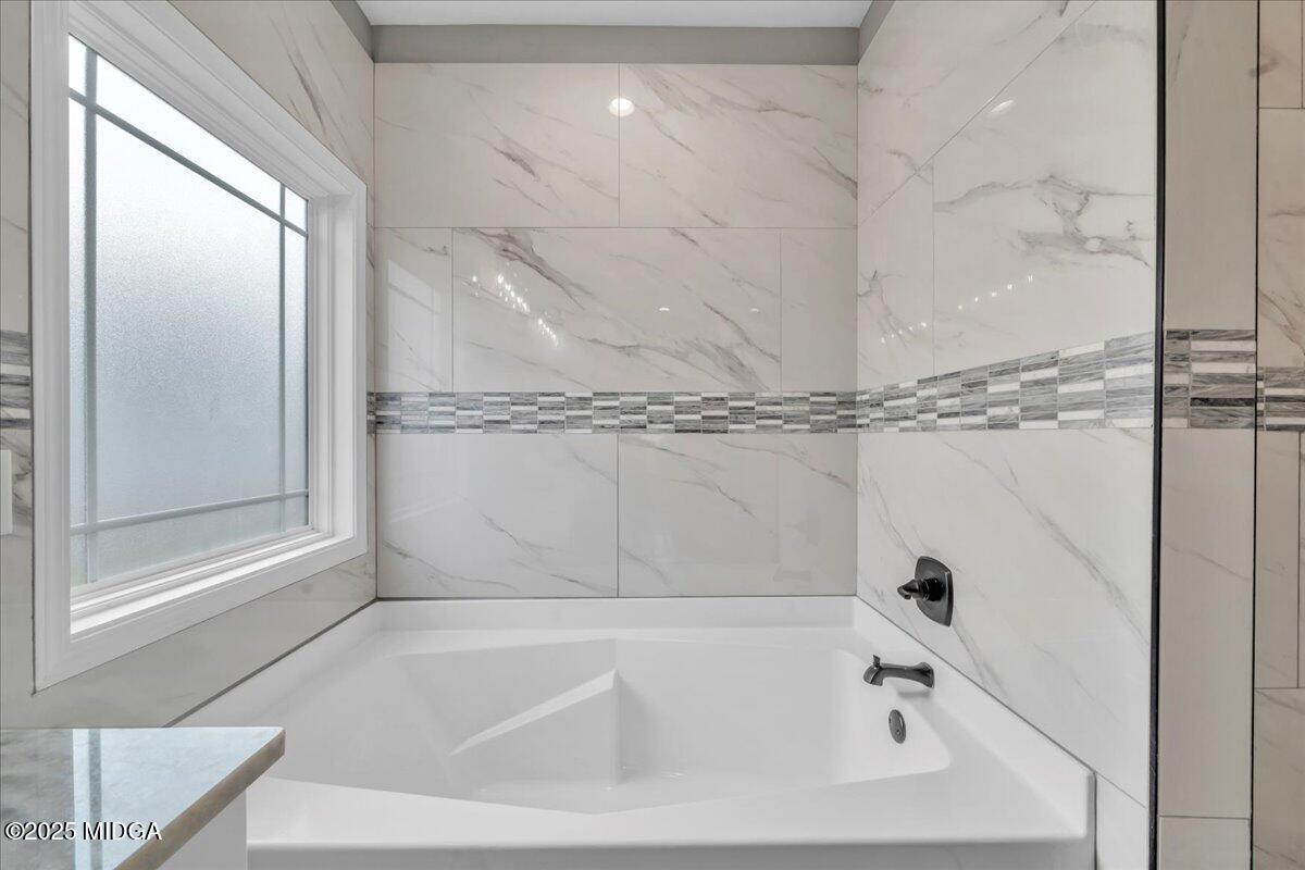 200 Eric Court Byron, GA 31008 - Photo 41 of 58 a bathroom with a tub and a shower