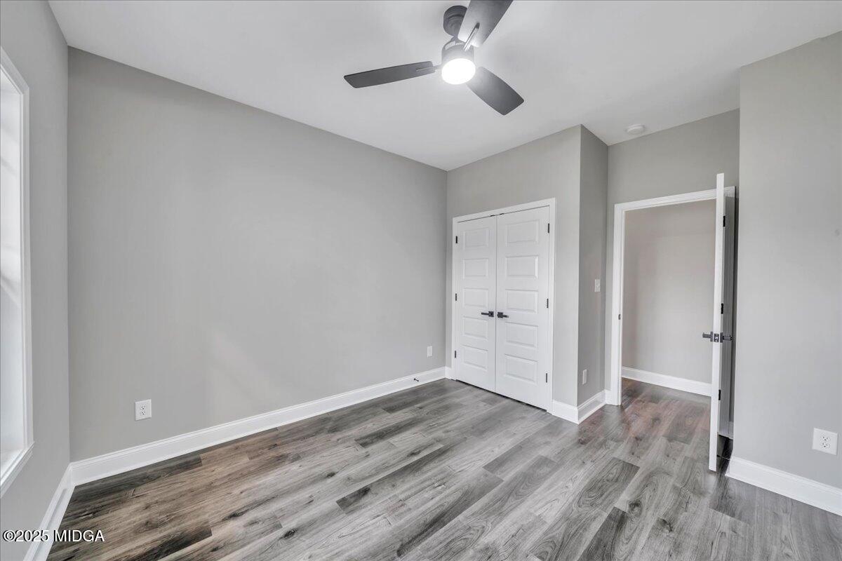 200 Eric Court Byron, GA 31008 - Photo 43 of 58 an empty room with wooden floor and ceiling fan