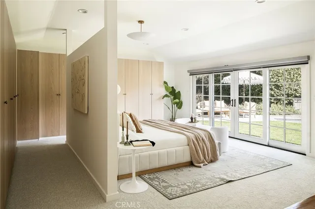 a bed room with a bed and a large window