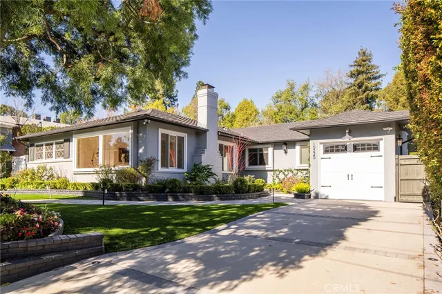 a front view of a house with a yard fire pit and outdoor seating