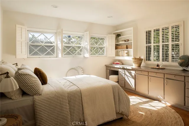 a bedroom with a bed and a large window