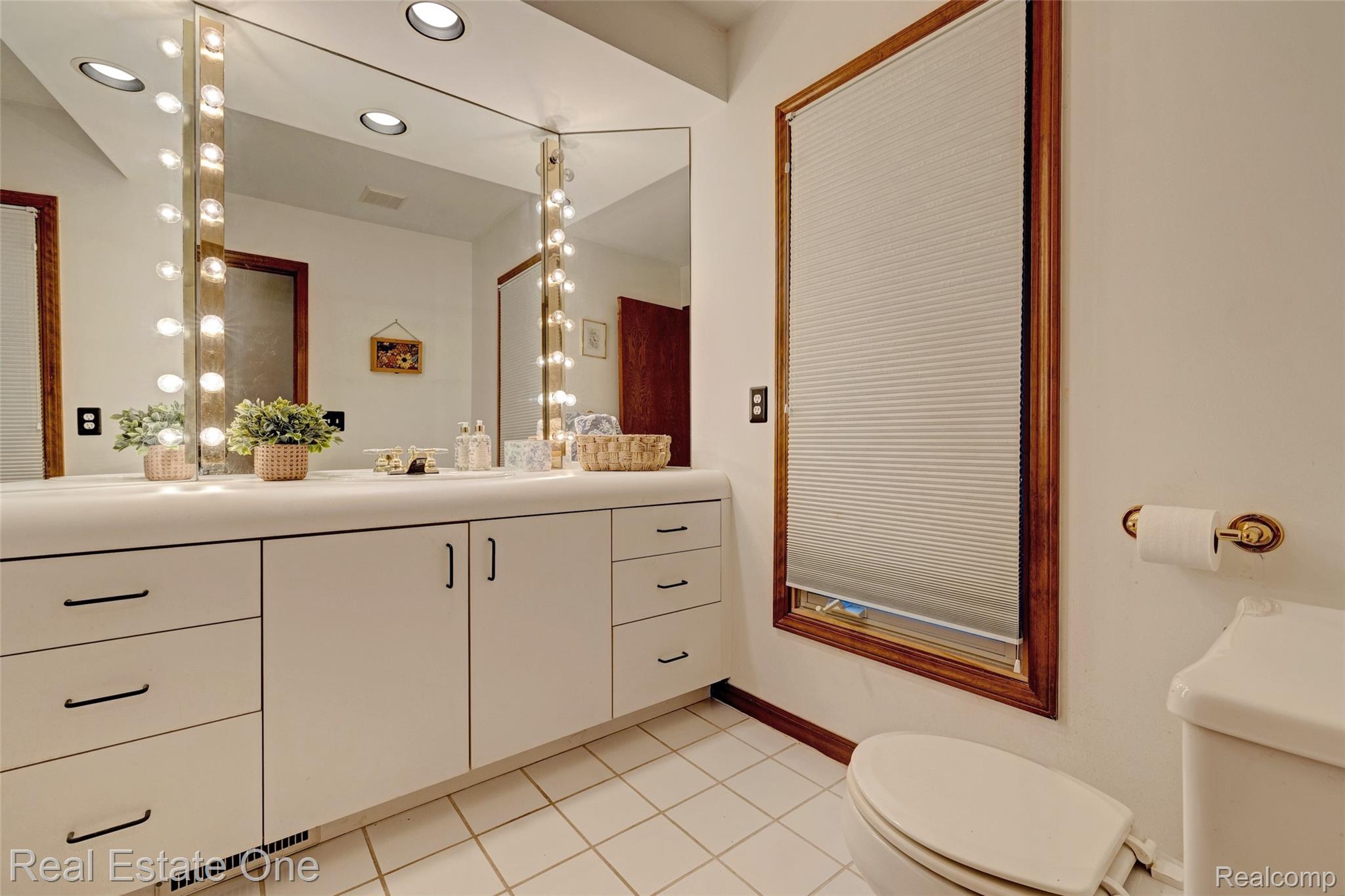 6400 Oakhill Road Ortonville, MI 48462 - Photo 26 of 82 Half bath with vanity, light tile patterned floors, and recessed lighting