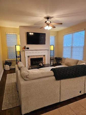 a kitchen with granite countertop a stove a microwave and wooden cabinets