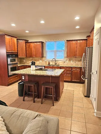 a kitchen with a refrigerator and a sink