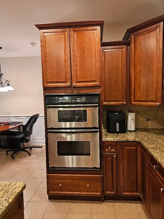 a bathroom with a tub a sink double vanity and a large mirror