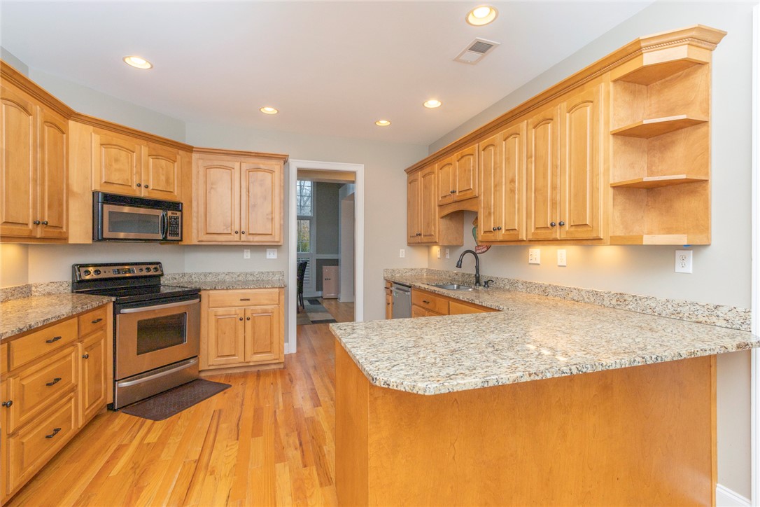 105 Sycamore Drive Clemson, SC 29631 - Photo 12 of 35 This spacious kitchen features ample counter space, rich wood cabinetry, and a bright, inviting atmosphere.