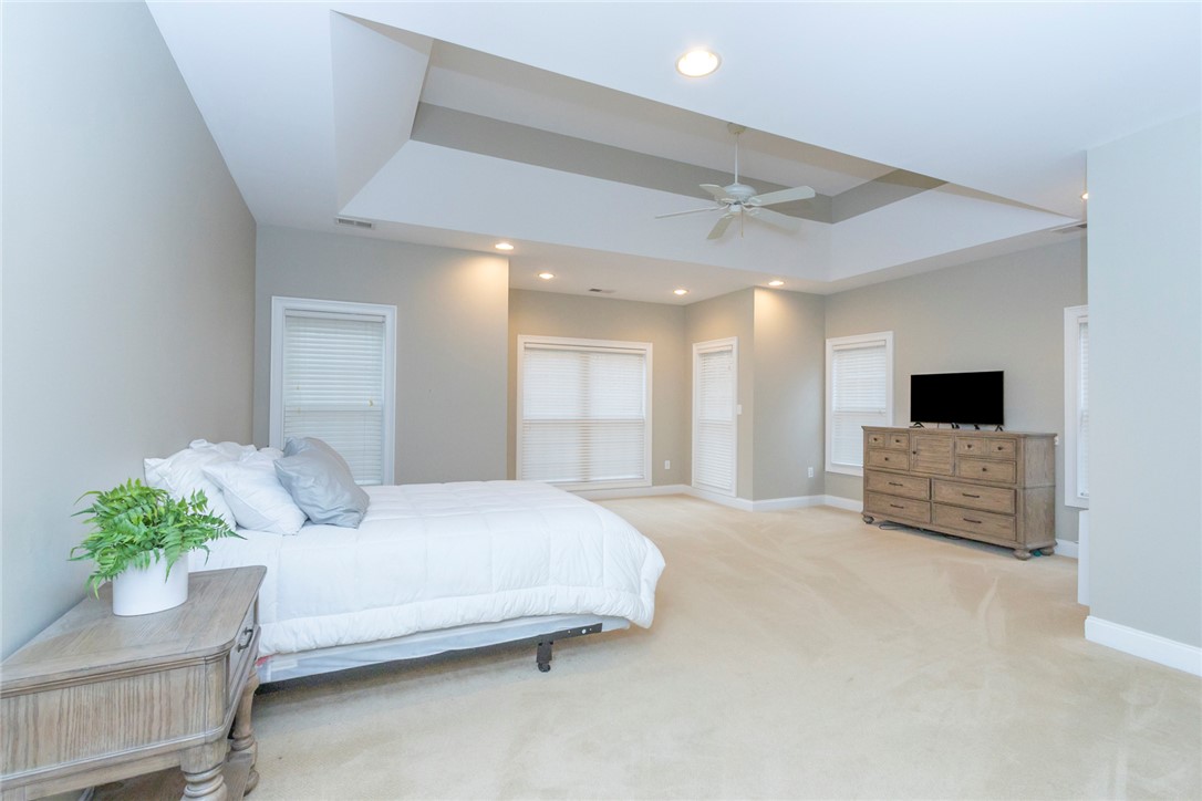 105 Sycamore Drive Clemson, SC 29631 - Photo 21 of 35 This expansive primary bedroom offers a tranquil retreat with soft carpet flooring and abundant natural light.