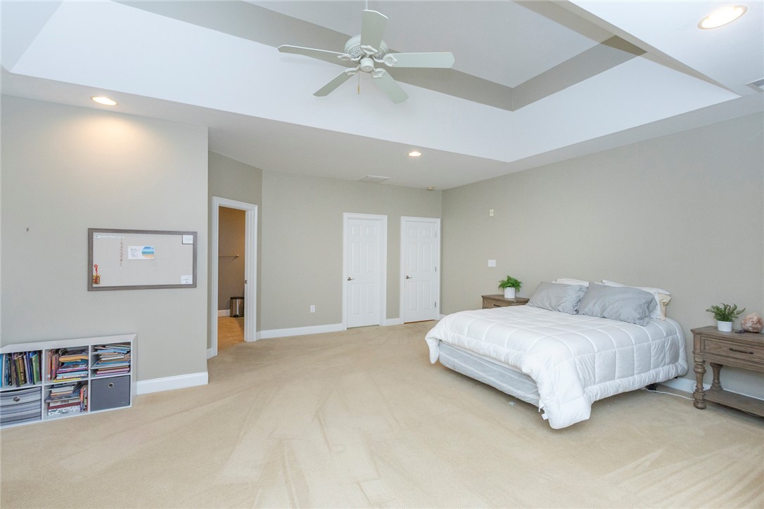 105 Sycamore Drive Clemson, SC 29631 - Photo 22 of 35 Generous bedroom features vaulted ceiling and soft carpet flooring, creating a comfortable and inviting atmosphere.