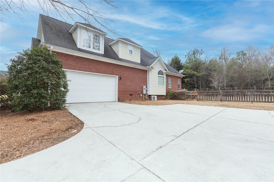 105 Sycamore Drive Clemson, SC 29631 - Photo 32 of 35 This classic brick and siding home features an attached garage and a concrete driveway.