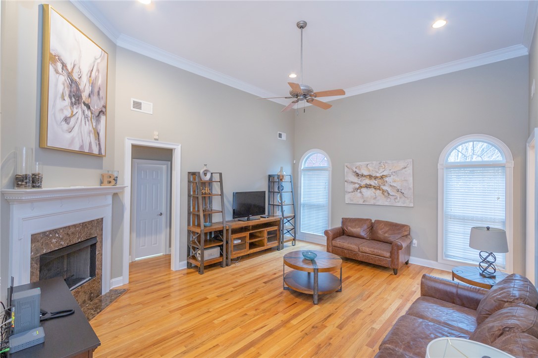 105 Sycamore Drive Clemson, SC 29631 - Photo 7 of 35 This inviting living space features warm hardwood floors and a cozy fireplace, perfect for relaxing.
