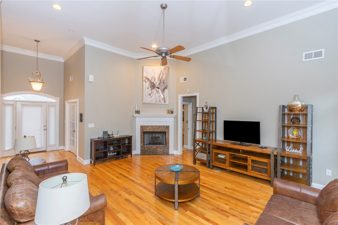 105 Sycamore Drive Clemson, SC 29631 - Photo 8 of 35 This living area features a fireplace, warm hardwood flooring, and abundant natural light.