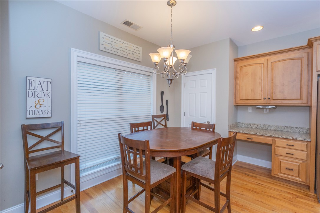 105 Sycamore Drive Clemson, SC 29631 - Photo 10 of 35 This inviting dining area features natural light, a chandelier, and warm wood flooring.