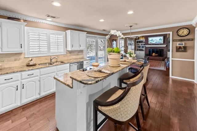 a kitchen with a dining table chairs and window