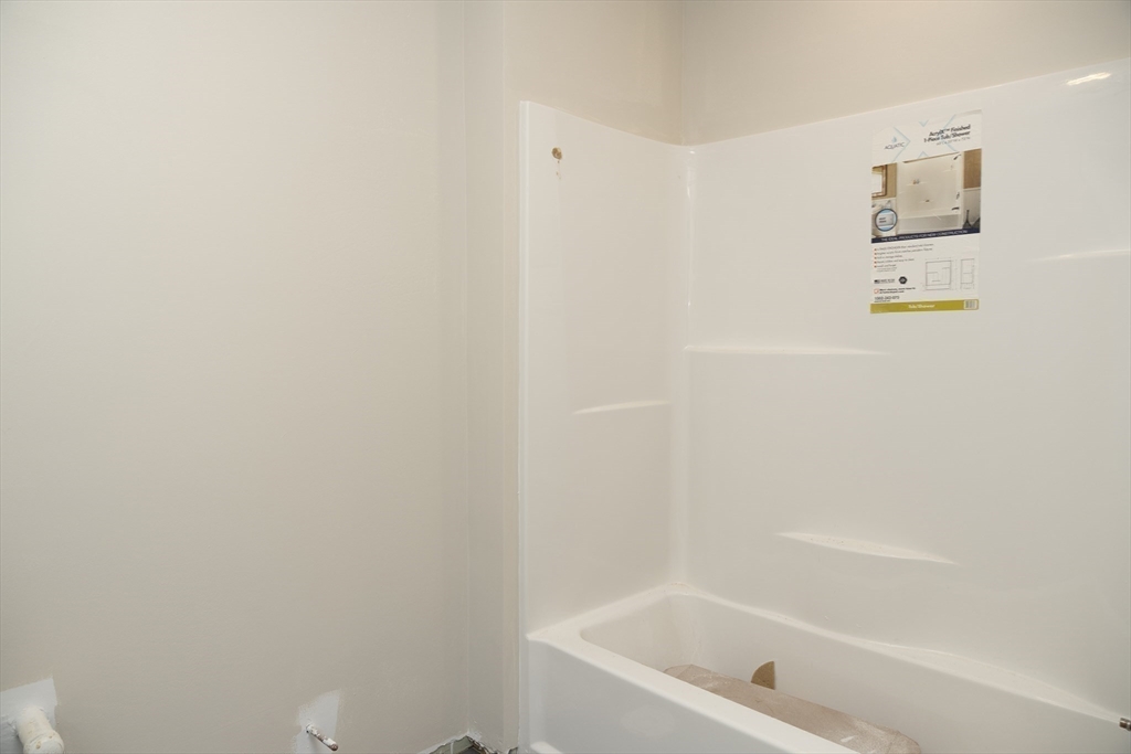 28 Marion Road Rochester, MA 02770 - Photo 20 of 23 a white bath tub sitting next to a white wall