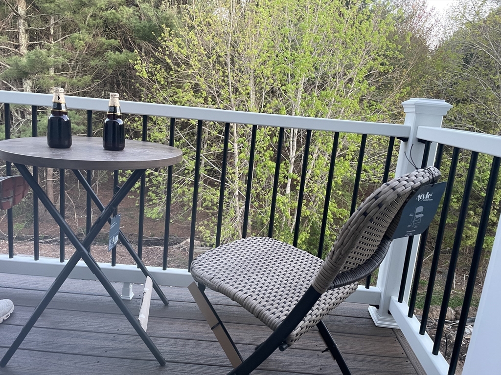 28 Marion Road Rochester, MA 02770 - Photo 5 of 23 a view of a balcony with wooden floor and outdoor seating