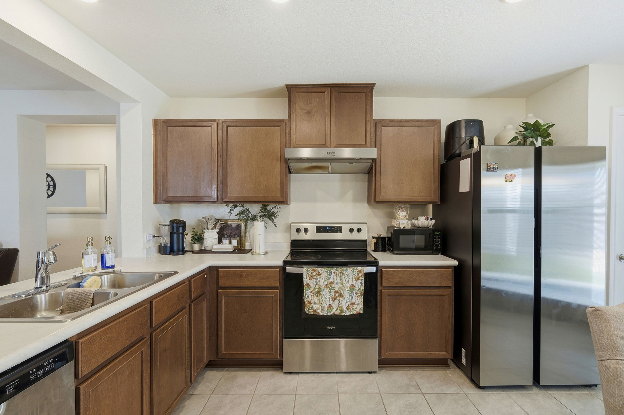220 Lucky Texan Road Jarrell, TX 76537 - Photo 6 of 19 A well-appointed kitchen features warm wooden cabinetry and gleaming stainless steel appliances.