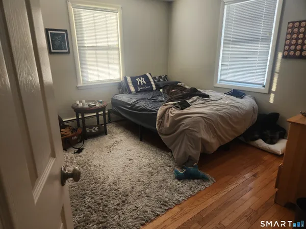 a bed sitting in a bedroom next to a window