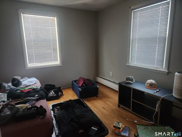 a room with a window and wooden floor