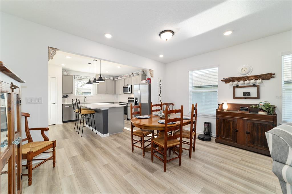 8392 Southwest 54th Street Ocala, FL 34481 - Photo 11 of 59 a kitchen with stainless steel appliances kitchen island granite countertop furniture and a dining table