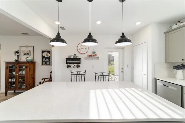 a bedroom with a bed and large windows