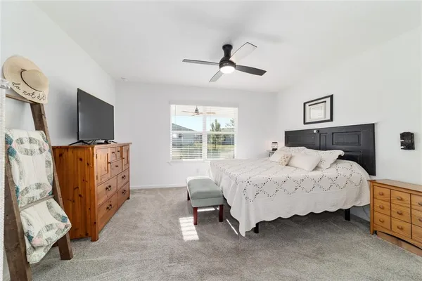 a spacious bathroom with a double vanity sink a mirror and a shower