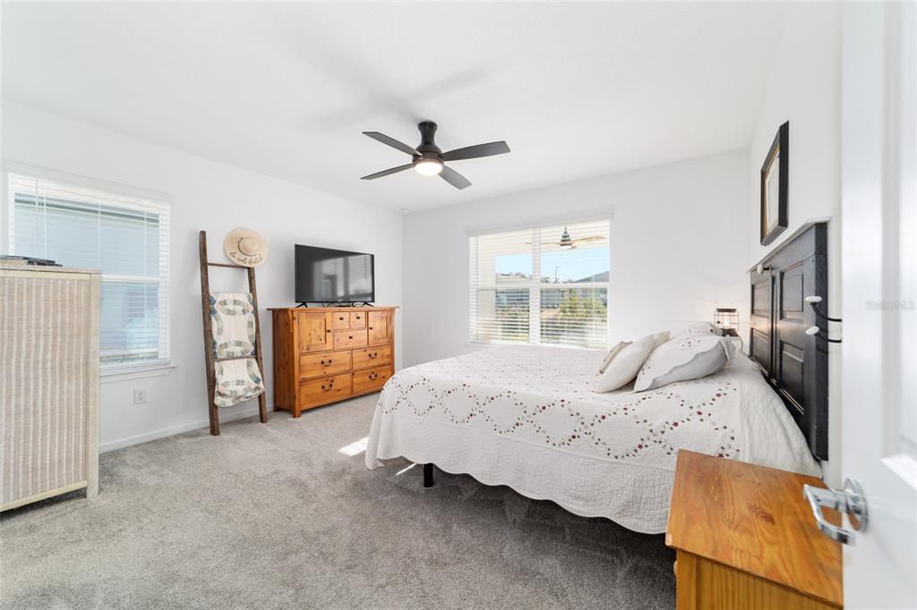 8392 Southwest 54th Street Ocala, FL 34481 - Photo 18 of 59 a bedroom with a bed and large windows