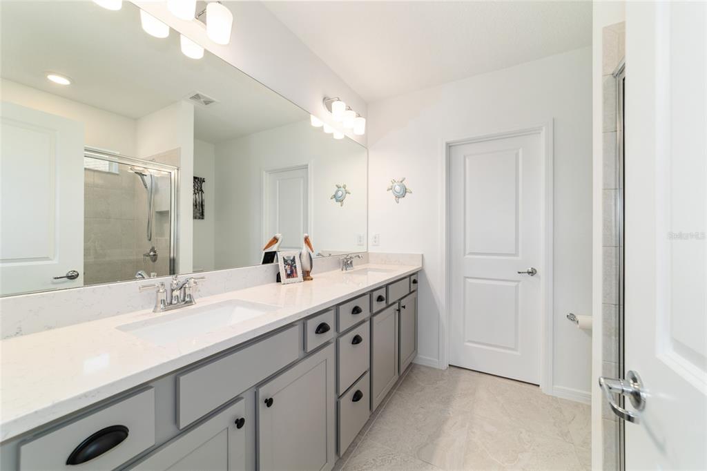 8392 Southwest 54th Street Ocala, FL 34481 - Photo 19 of 59 a spacious bathroom with a double vanity sink a mirror and a shower