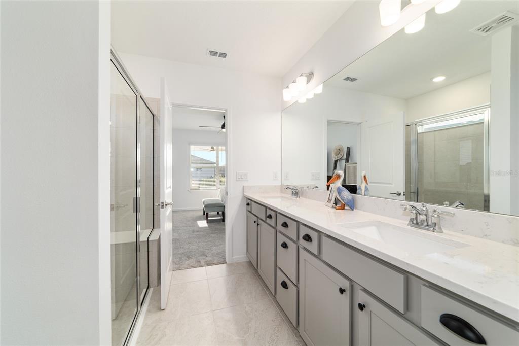 8392 Southwest 54th Street Ocala, FL 34481 - Photo 20 of 59 a spacious bathroom with a double vanity sink mirror and shower