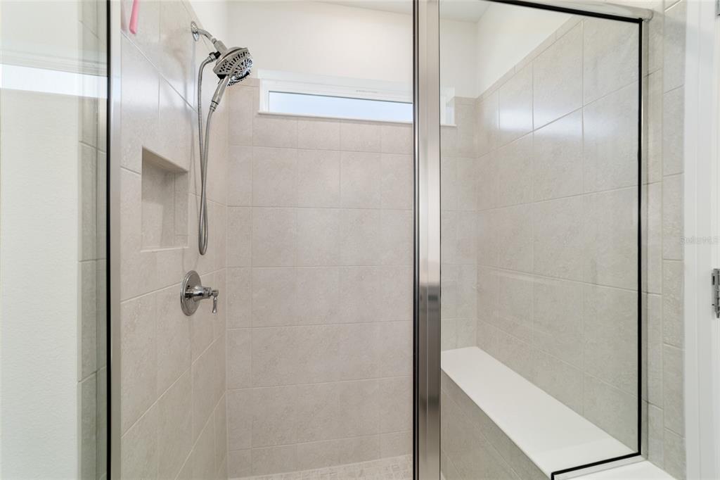 8392 Southwest 54th Street Ocala, FL 34481 - Photo 21 of 59 a bathroom with a glass shower door