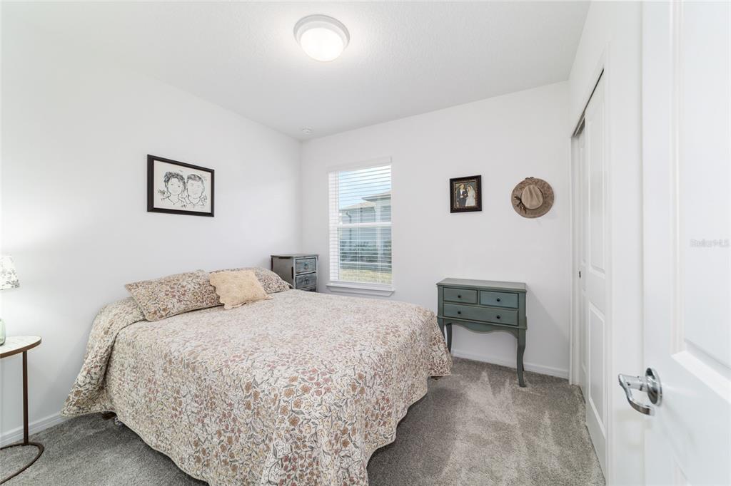 8392 Southwest 54th Street Ocala, FL 34481 - Photo 25 of 59 a bedroom with a bed and a chair