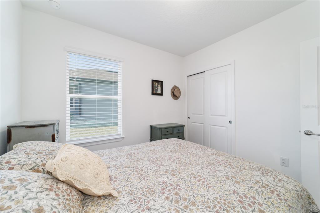 8392 Southwest 54th Street Ocala, FL 34481 - Photo 26 of 59 a bedroom with a bed and a window