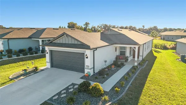 an aerial view of a house with swimming pool patio and outdoor seating