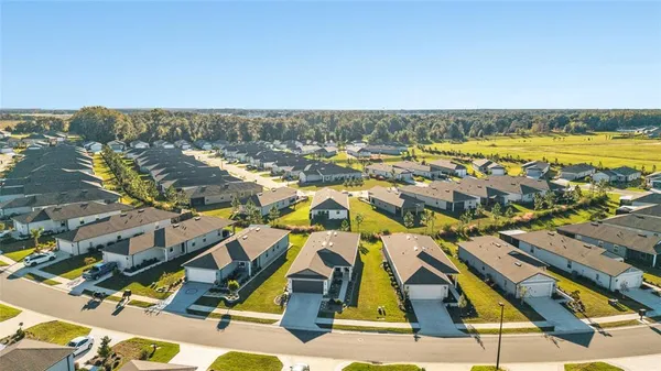 an aerial view of residential house with outdoor space and lake view