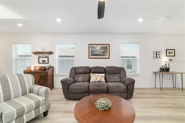 a dining room with furniture and wooden floor