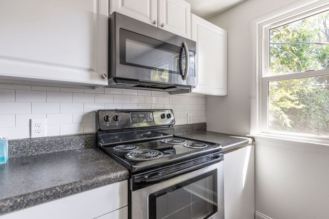 a kitchen with a stove and a microwave