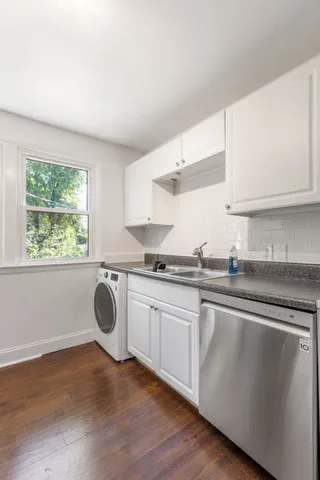 a kitchen with a sink cabinets and window