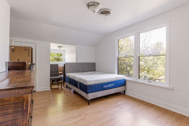a living room with a bed furniture and a large window