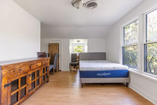a bedroom with furniture and window
