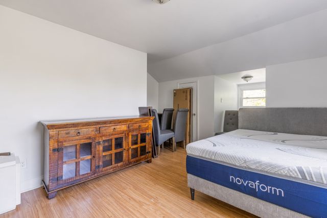 a bedroom with a bed and a dresser